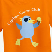 Orange t-shirt with a cartoon penguin character and 'Captain Scoop Club' text on an orange background.