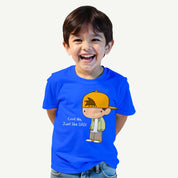 Child wearing a blue t-shirt with a cartoon character and text on a white background