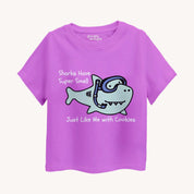 lavender t-shirt with a cartoon shark and text on a white background