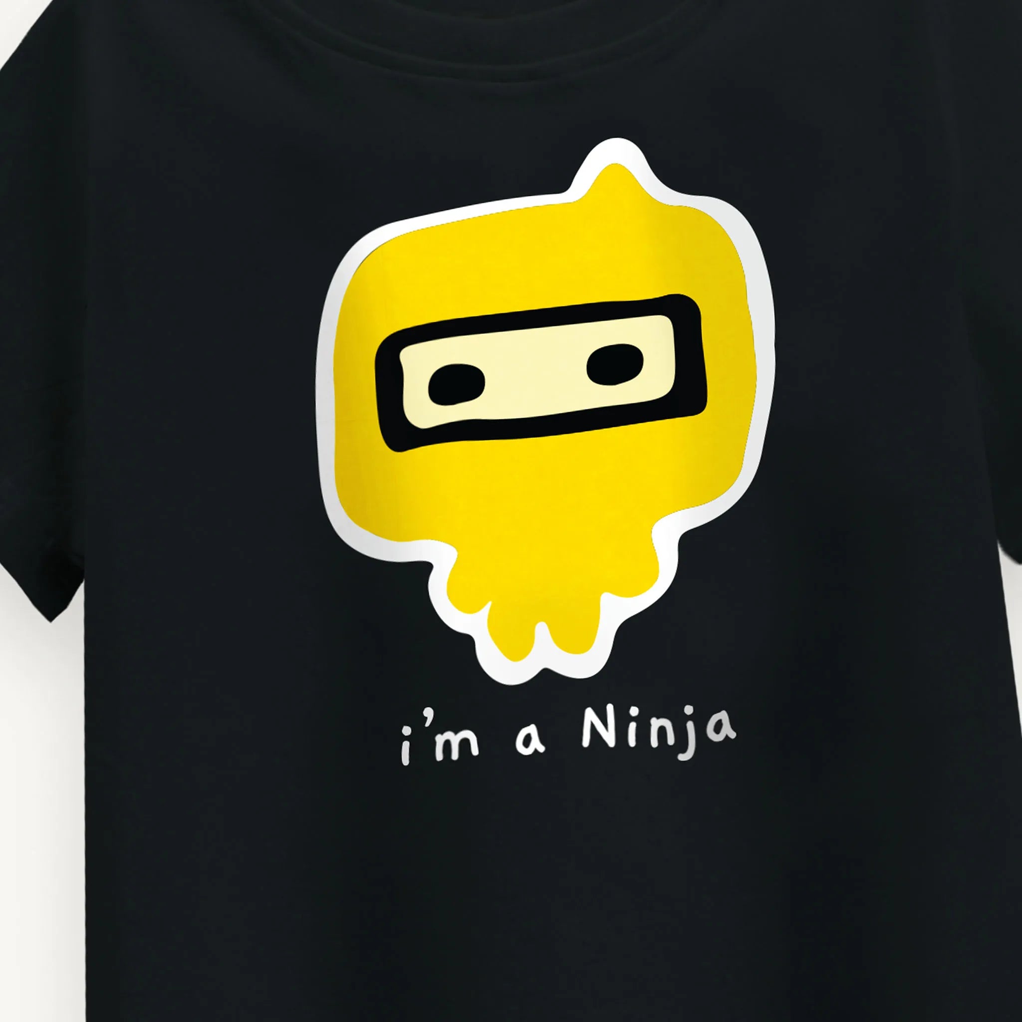 Close-up of the 'I Am Ninja' graphic print on the Boys oversized black T-Shirt, emphasizing the bold and playful ninja theme for ages 5-12.