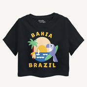 Black t-shirt with 'Bahia Brazil' design featuring a parrot, palm tree, and sun on a white background.
