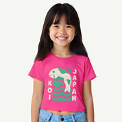 Child wearing a pink t-shirt with a graphic design on a white background