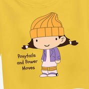 Yellow croptop with a cartoon character and text 'Ponytails and Power Moves' on a yellow background