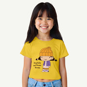 Child wearing a yellow croptop with a cartoon character and text on a white background