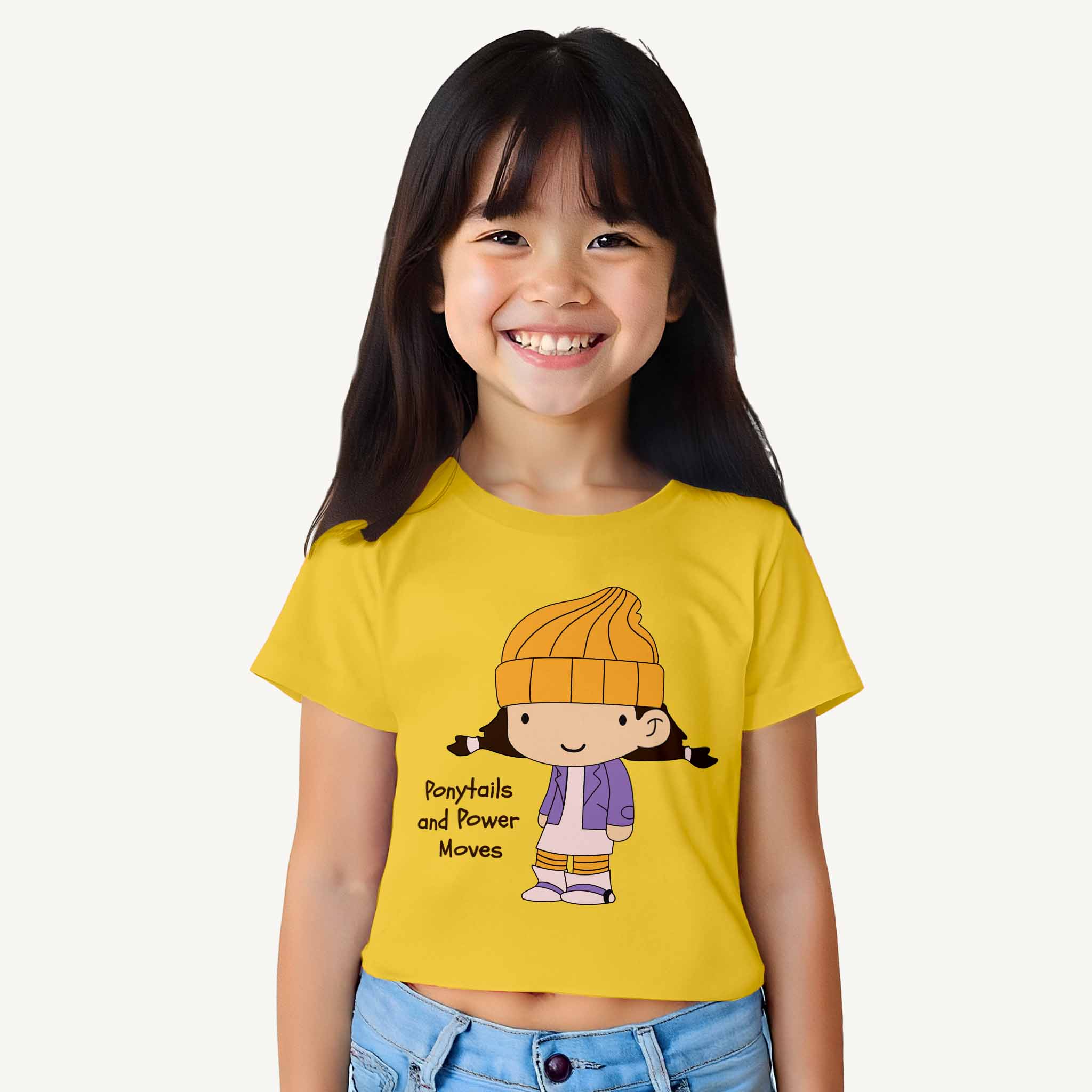 Child wearing a yellow croptop with a cartoon character and text on a white background