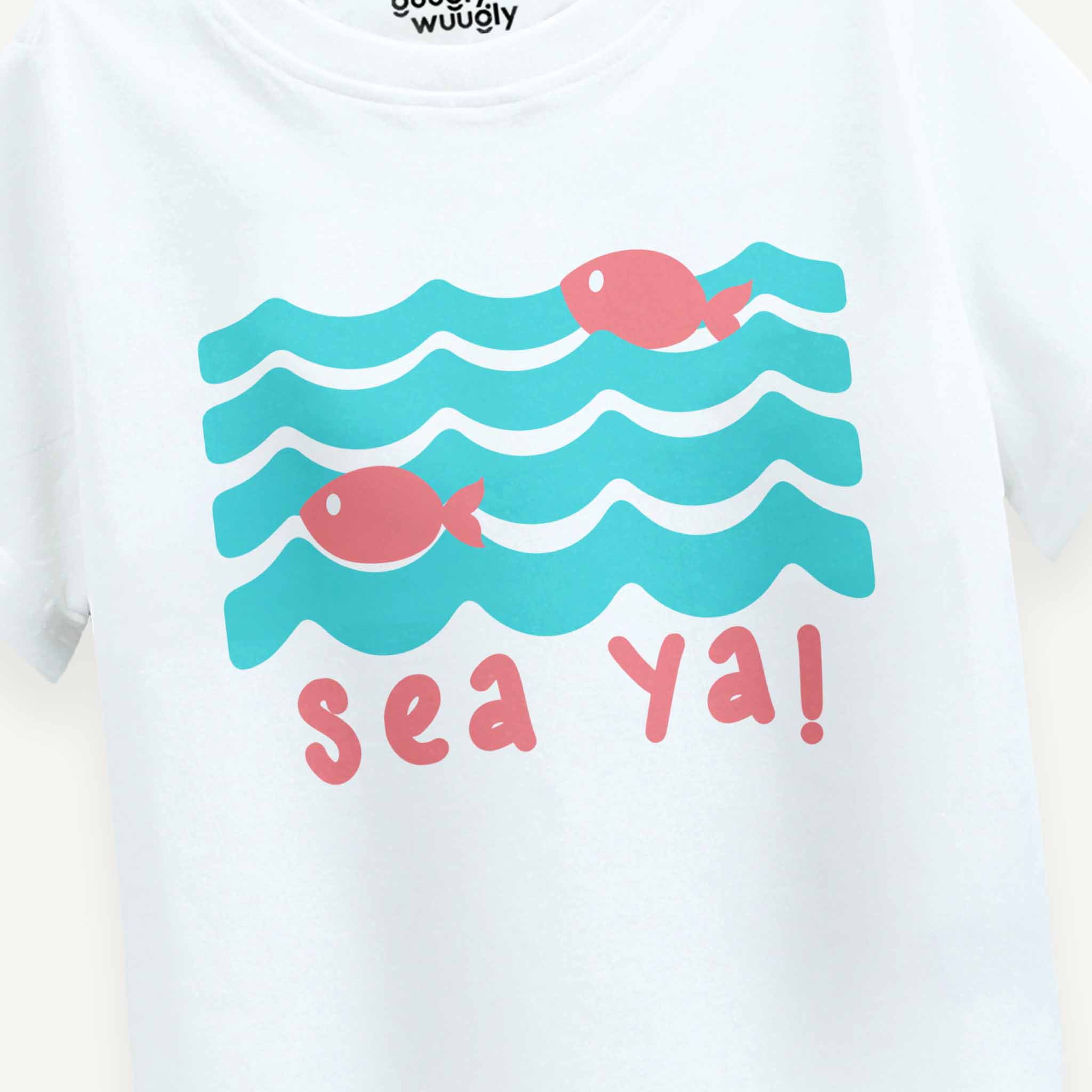 White shirt with blue waves and pink fish design, featuring the text 'sea ya!'.