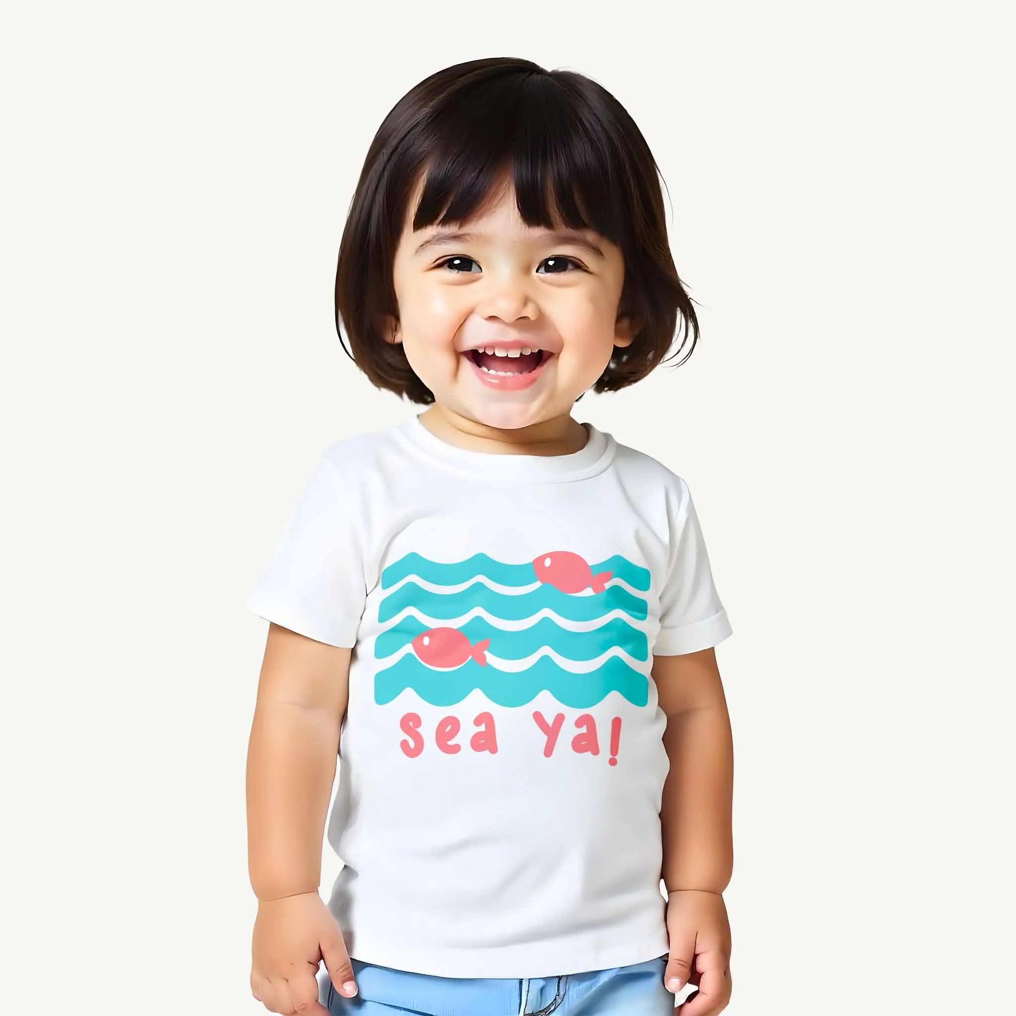 Child wearing a white t-shirt with a fish and wave design and text on a white background