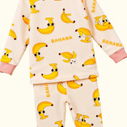 Children's pajama set with banana pattern on a beige background