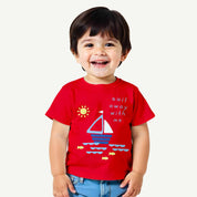 Child wearing a red t-shirt with a sailboat design on a white background