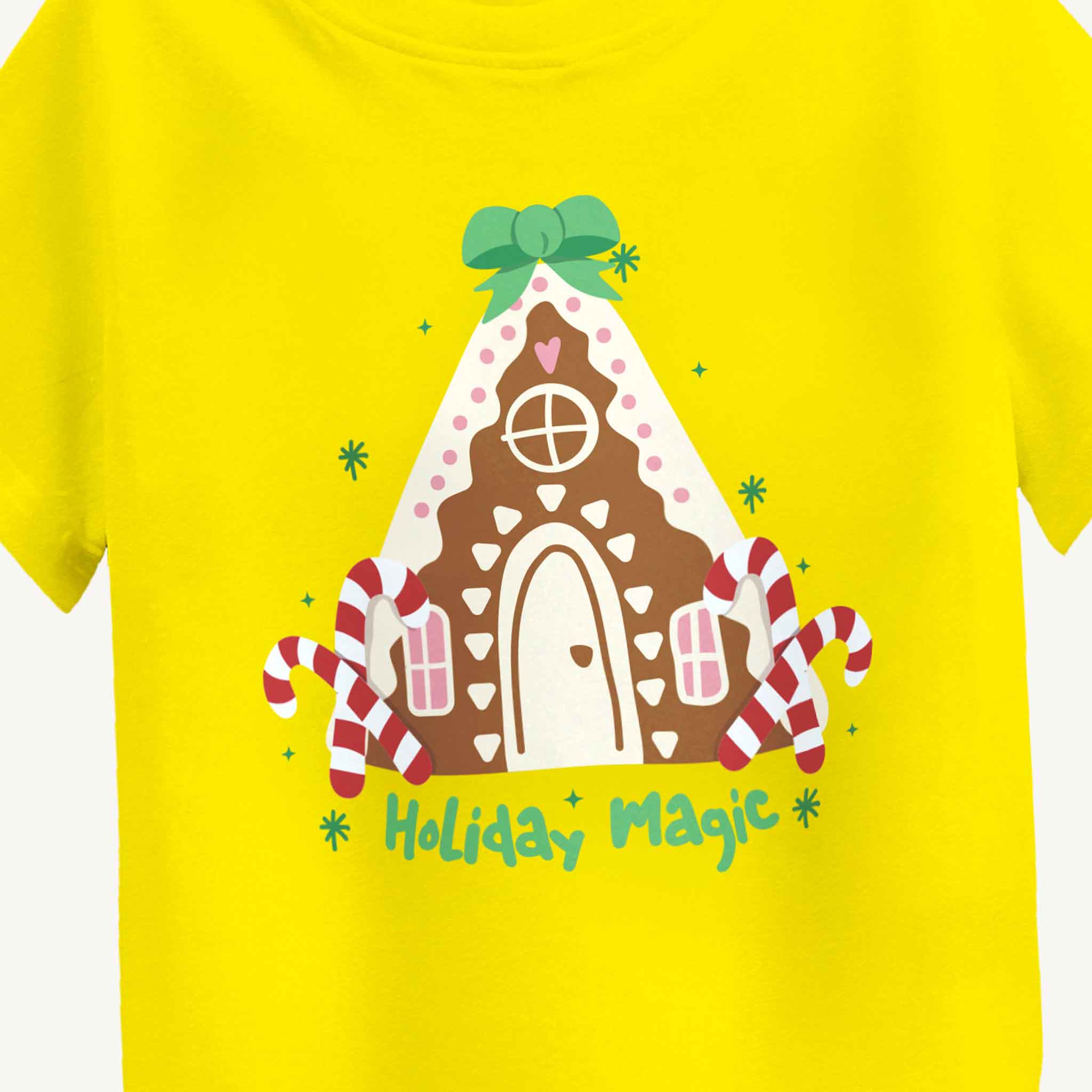 Yellow t-shirt with a gingerbread house design and 'Holiday Magic' text on a white background