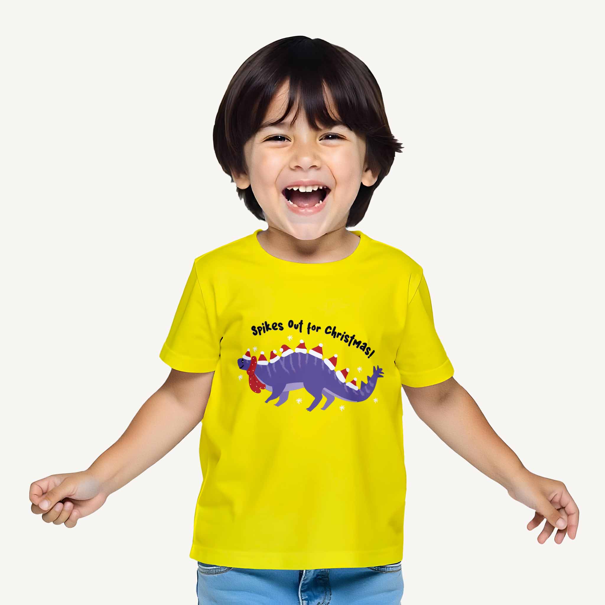 Child wearing a yellow t-shirt with a dinosaur graphic and text on a white background