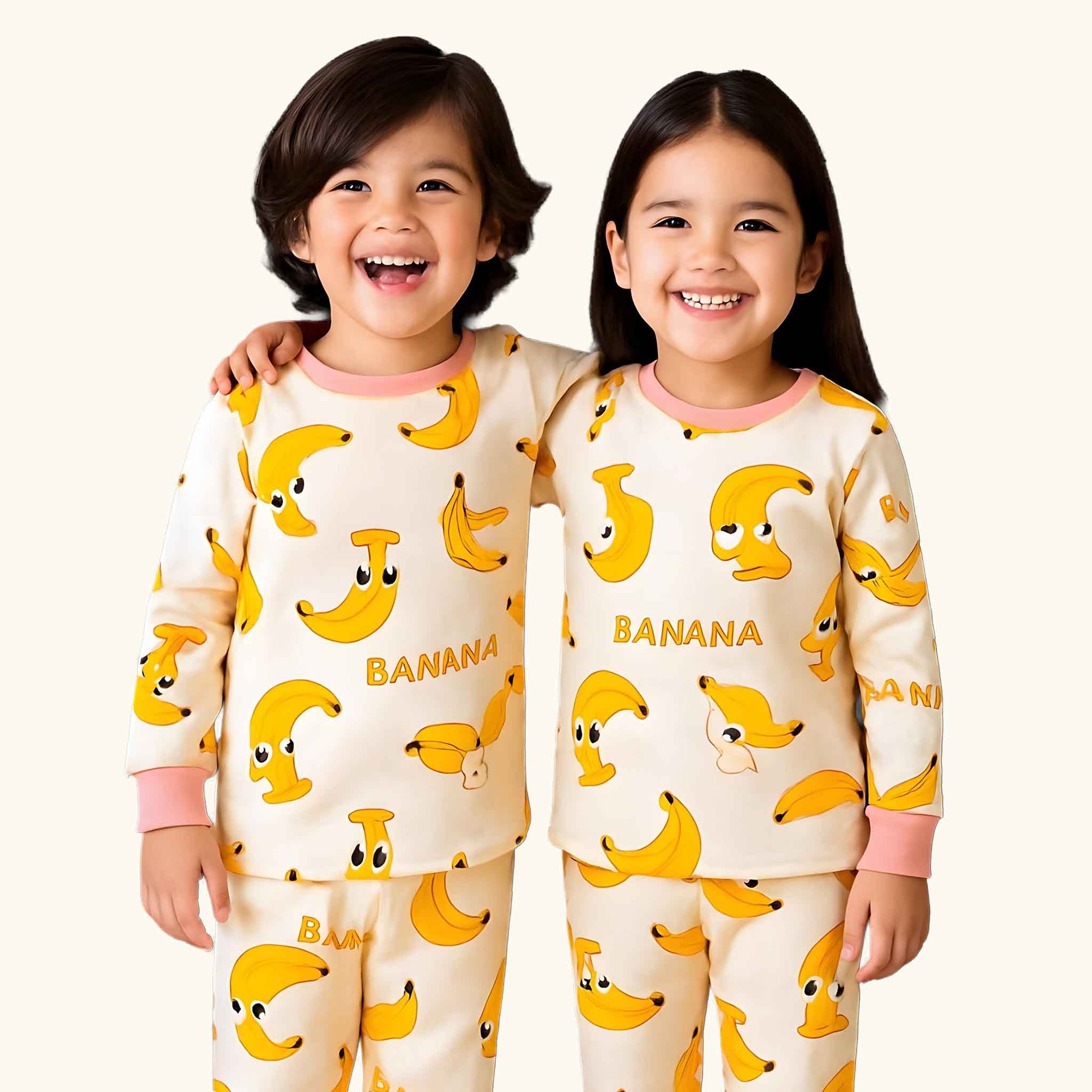 Two children wearing pajamas with banana pattern on a white background