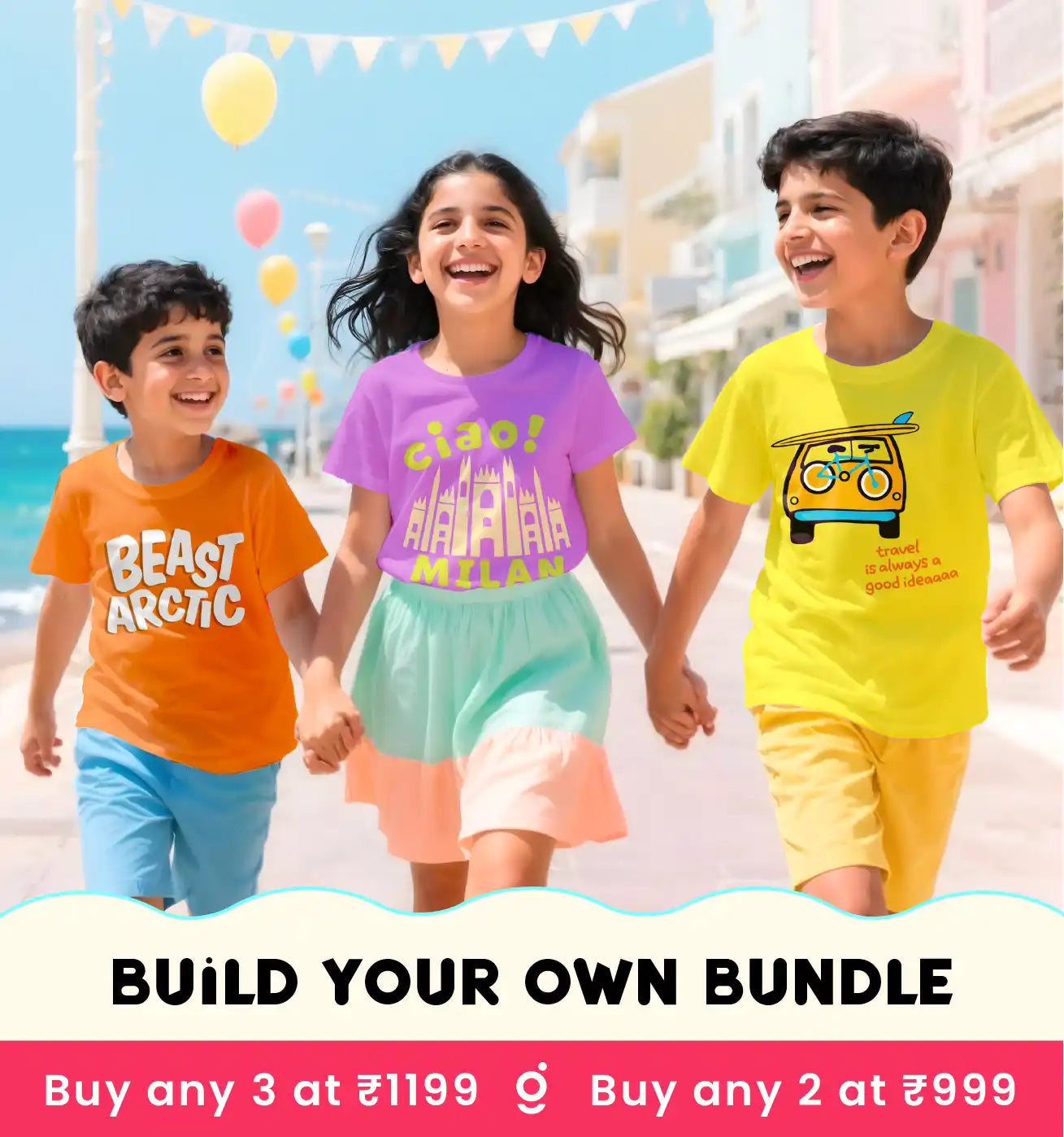 Three children holding hands on a beach, wearing colorful t-shirts with text and graphics.