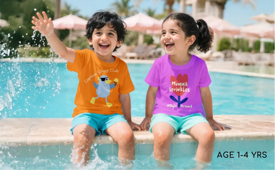 Two children sitting by a pool, wearing colorful shirts with cartoon characters.